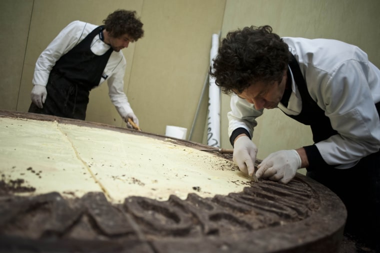 The largest chocolate coin weighs 658kg (1450 lbs), measures 196cm in diameter and is 17cm thick. It was created by the master chocolatiers at the Cioccoshow Exhibition, during an event arranged by BF Servizi (Italy), in Bologna, Italy on 15 November 2012 to celebrate Guinness World Records Day.